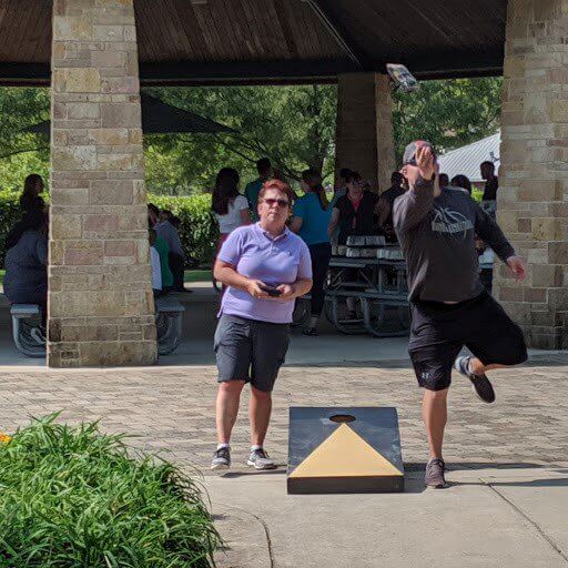 Two Baker Hill associates playing games at the company picnic.